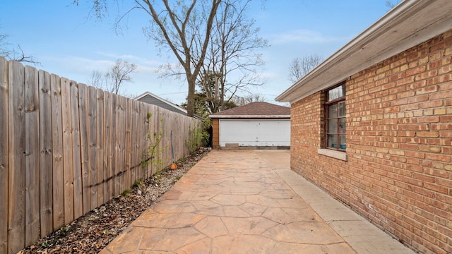 36 Monee Rd, Park Forest, IL 60466 - view of patio featuring a garage and an outdoor structure