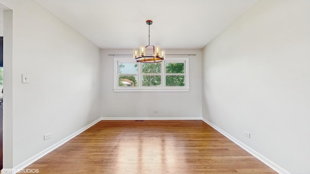 4265 Portage Ln, Hoffman Estates, IL 60192 - empty room featuring a chandelier and wood finished floors