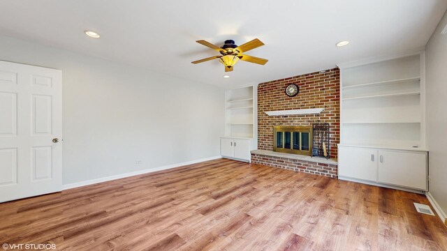 4265 Portage Ln, Hoffman Estates, IL 60192 - unfurnished living room with a ceiling fan, built in shelves, wood finished floors, a brick fireplace, and recessed lighting