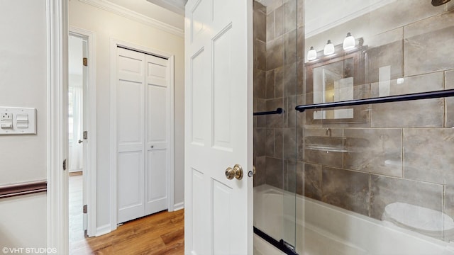 4265 Portage Ln, Hoffman Estates, IL 60192 - full bath featuring ornamental molding, shower / bath combination with glass door, wood finished floors, and a closet