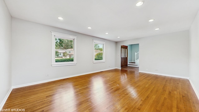 4265 Portage Ln, Hoffman Estates, IL 60192 - unfurnished room featuring wood finished floors, recessed lighting, and stairs