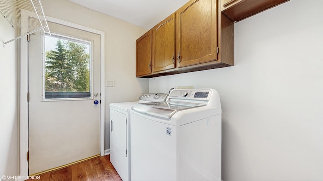 4265 Portage Ln, Hoffman Estates, IL 60192 - laundry area with cabinet space, independent washer and dryer, and wood finished floors
