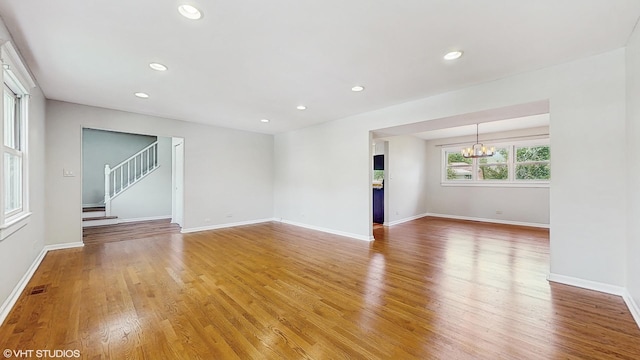 4265 Portage Ln, Hoffman Estates, IL 60192 - empty room with a chandelier, light wood-type flooring, recessed lighting, and stairway