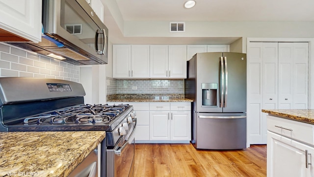 4265 Portage Ln, Hoffman Estates, IL 60192 - kitchen with appliances with stainless steel finishes, light wood-style flooring, white cabinetry, light stone countertops, and backsplash