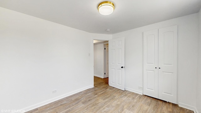 22201 Windsor Ct, Richton Park, IL 60471 - unfurnished bedroom featuring light wood-style flooring and a closet