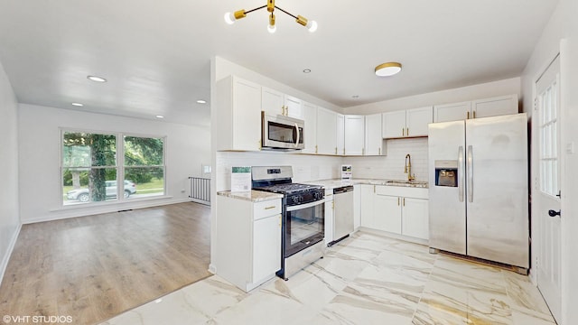 22201 Windsor Ct, Richton Park, IL 60471 - kitchen featuring appliances with stainless steel finishes, light stone countertops, decorative backsplash, white cabinets, and recessed lighting