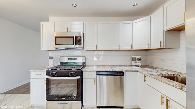 22201 Windsor Ct, Richton Park, IL 60471 - kitchen featuring appliances with stainless steel finishes, light stone countertops, backsplash, and white cabinetry
