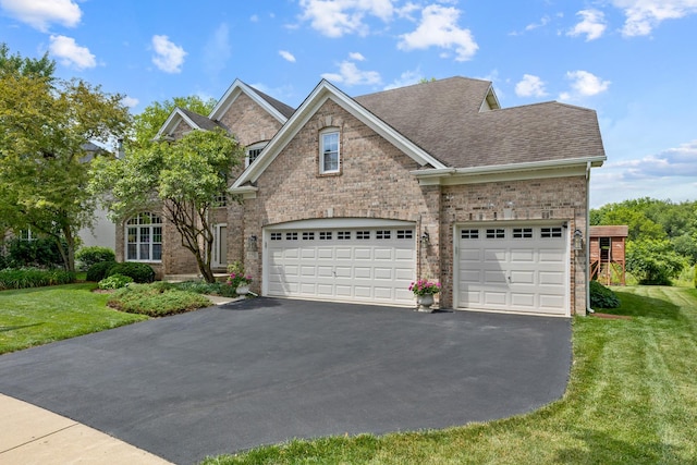 2251 Sutton Dr, South Elgin, IL 60177 - view of front of home featuring asphalt driveway, brick siding, a front yard, and a shingled roof