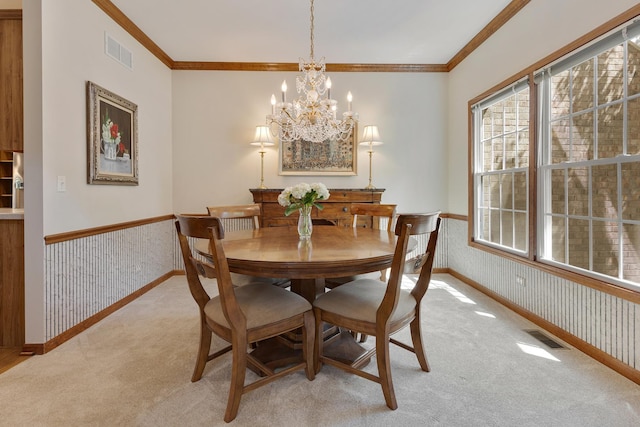 2251 Sutton Dr, South Elgin, IL 60177 - dining room with light colored carpet, a chandelier, crown molding, plenty of natural light, and a wainscoted wall
