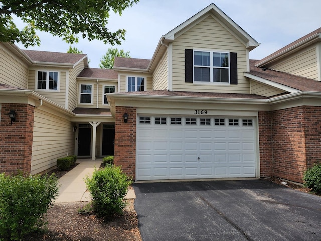3169 Pearl St, Elgin, IL 60124 - view of front facade featuring asphalt driveway, brick siding, and an attached garage