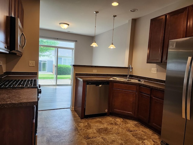 3169 Pearl St, Elgin, IL 60124 - kitchen with appliances with stainless steel finishes, dark countertops, a peninsula, dark brown cabinets, and pendant lighting