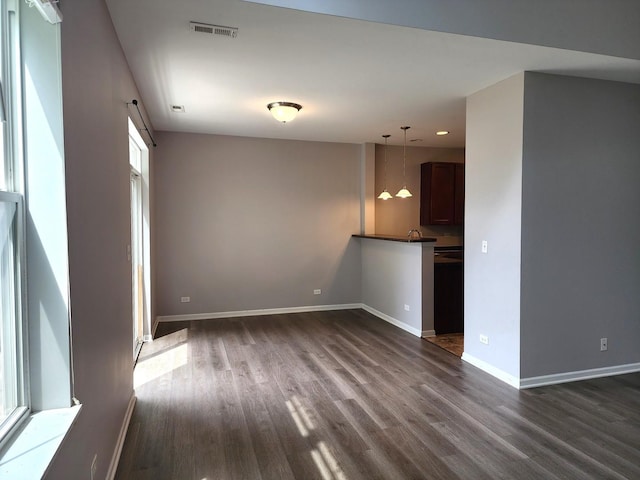 3169 Pearl St, Elgin, IL 60124 - unfurnished living room with dark wood-type flooring and recessed lighting