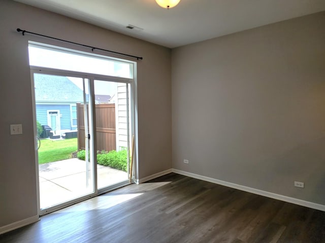 3169 Pearl St, Elgin, IL 60124 - spare room featuring dark wood-style floors and baseboards
