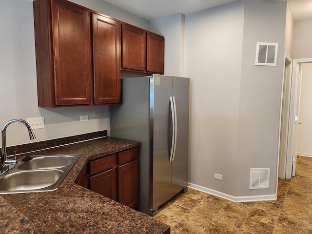 3169 Pearl St, Elgin, IL 60124 - kitchen featuring freestanding refrigerator, dark countertops, and light stone finish floors