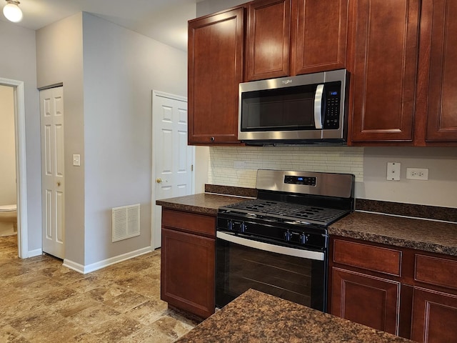 3169 Pearl St, Elgin, IL 60124 - kitchen with appliances with stainless steel finishes, dark countertops, and tasteful backsplash