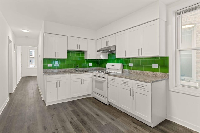 2507 W 45th Pl, Chicago, IL 60632 - kitchen featuring white gas range, under cabinet range hood, white cabinets, dark wood-style flooring, and tasteful backsplash