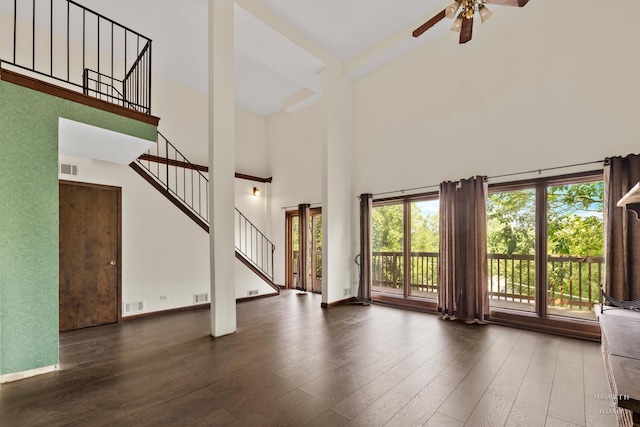 294 Apache Trl, Lake In The Hills, IL 60156 - unfurnished living room with a towering ceiling, ceiling fan, stairs, and wood finished floors