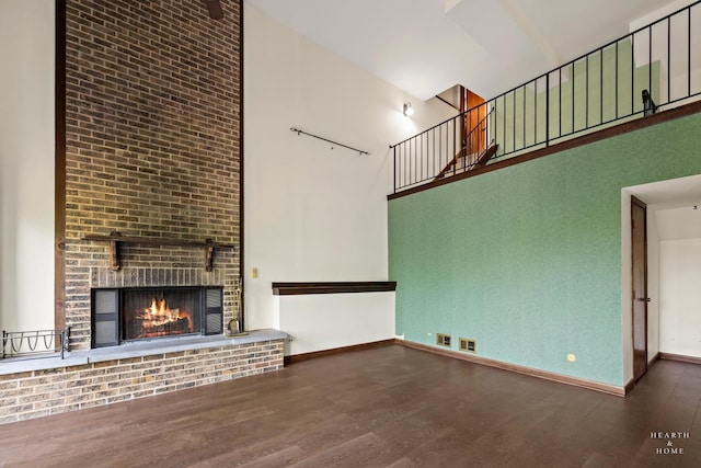 294 Apache Trl, Lake In The Hills, IL 60156 - unfurnished living room with a high ceiling, wood finished floors, and a fireplace