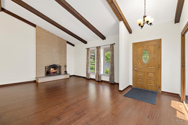 294 Apache Trl, Lake In The Hills, IL 60156 - entrance foyer featuring a chandelier, wood finished floors, and a brick fireplace