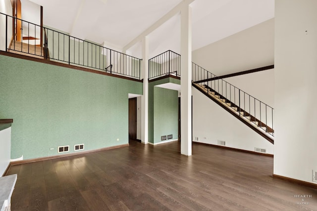 294 Apache Trl, Lake In The Hills, IL 60156 - unfurnished living room with a high ceiling, wood finished floors, and stairway