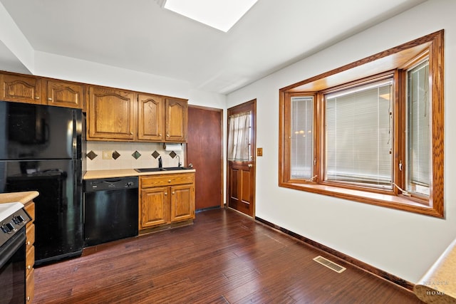 294 Apache Trl, Lake In The Hills, IL 60156 - kitchen with black appliances, tasteful backsplash, brown cabinetry, light countertops, and dark wood-style floors