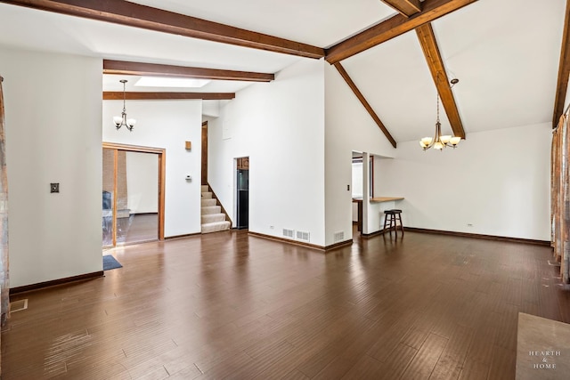 294 Apache Trl, Lake In The Hills, IL 60156 - unfurnished living room featuring a chandelier, beam ceiling, wood finished floors, high vaulted ceiling, and stairs