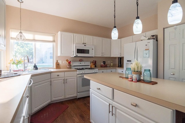 85 Fieldstone Dr, Lake Villa, IL 60046 - kitchen with white appliances, white cabinets, dark wood-style flooring, light countertops, and pendant lighting