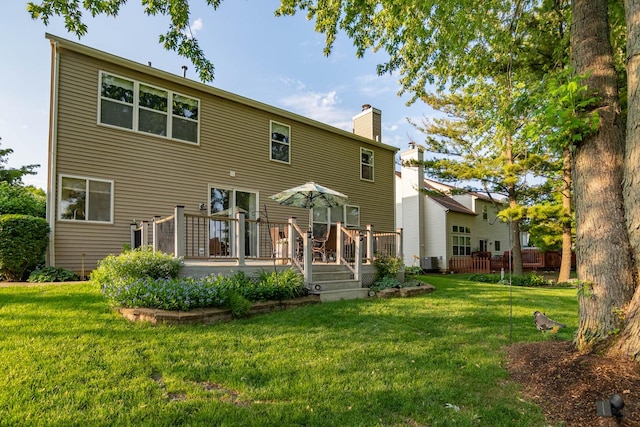 85 Fieldstone Dr, Lake Villa, IL 60046 - rear view of property featuring a chimney, a lawn, and a wooden deck