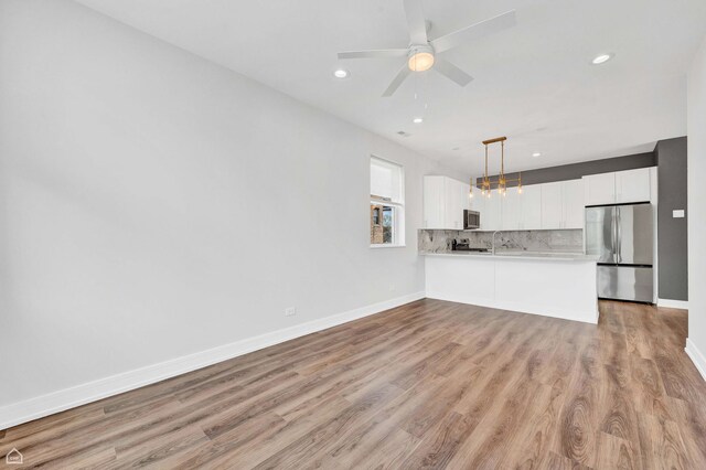 4435 S Prairie Ave, Chicago, IL 60653 - unfurnished living room featuring light wood finished floors, recessed lighting, and a ceiling fan