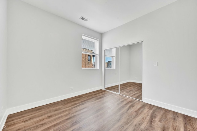 4435 S Prairie Ave, Chicago, IL 60653 - unfurnished bedroom featuring wood finished floors and a closet