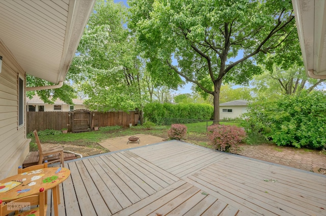 566 Ridge Ave, Elk Grove Village, IL 60007 - deck with a fenced backyard, a fire pit, and a gate
