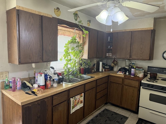 526 Gardner St, Joliet, IL 60433 - kitchen with gas range gas stove, light countertops, ceiling fan, open shelves, and dark brown cabinetry