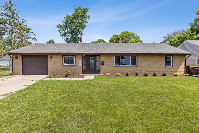 2221 Sharon Ave, Rockford, IL 61103 - ranch-style home with brick siding, a garage, a front lawn, and driveway