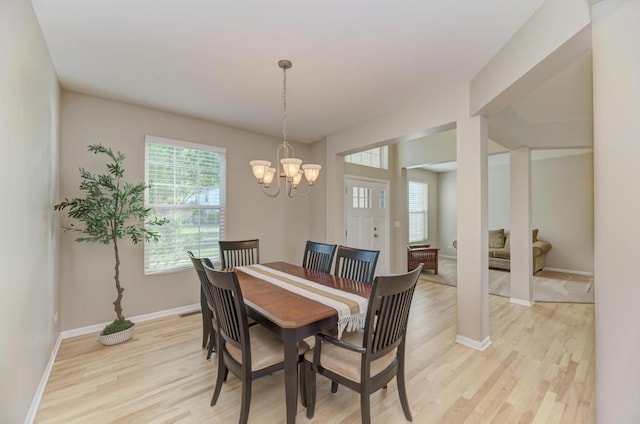 11703 Wolf Creek Ln, Plainfield, IL 60585 - dining area featuring light wood-style flooring and a chandelier