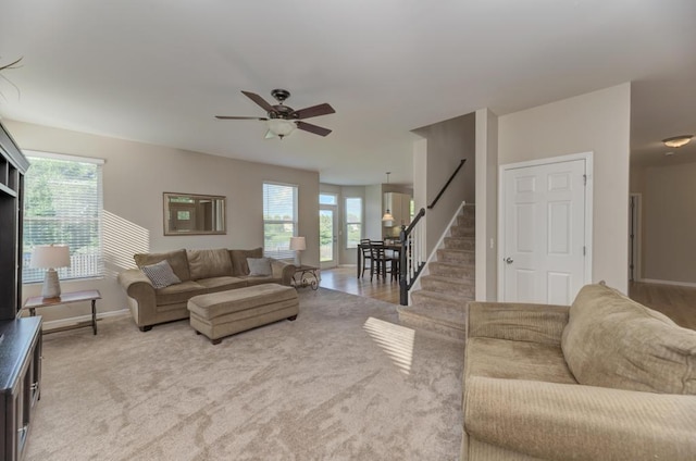 11703 Wolf Creek Ln, Plainfield, IL 60585 - living room featuring stairs, ceiling fan, and light carpet