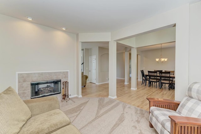 11703 Wolf Creek Ln, Plainfield, IL 60585 - living area with a chandelier, recessed lighting, wood finished floors, and a fireplace