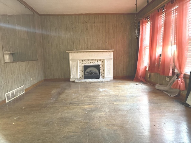 1826 S Kildare Ave, Chicago, IL 60623 - unfurnished living room with plenty of natural light, wood-type flooring, wood walls, and a fireplace with raised hearth