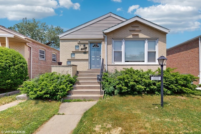 124 E 83rd St, Chicago, IL 60619 - view of front of property with a front yard, brick siding, and entry steps