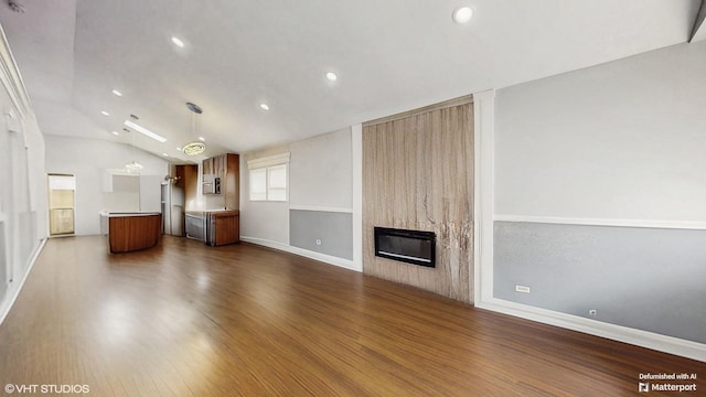 124 E 83rd St, Chicago, IL 60619 - unfurnished living room with a large fireplace, dark wood-style floors, lofted ceiling, and recessed lighting