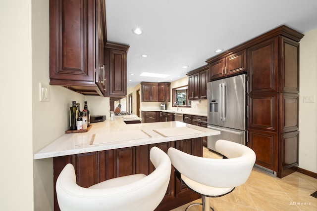 7 Bell Oak Ln, Lemont, IL 60439 - kitchen featuring stainless steel appliances, a peninsula, recessed lighting, dark brown cabinets, and a breakfast bar