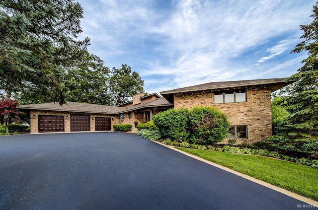 7 Bell Oak Ln, Lemont, IL 60439 - view of front of home featuring brick siding, asphalt driveway, an attached garage, and a front lawn