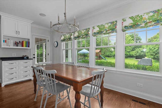 1111 Seneca Rd, Wilmette, IL 60091 - dining space featuring a chandelier, crown molding, and dark wood finished floors