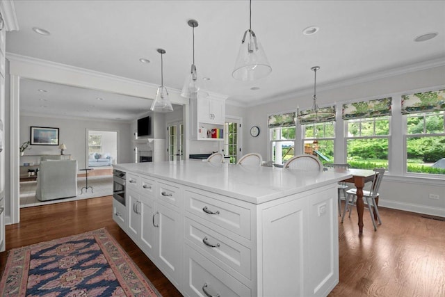 1111 Seneca Rd, Wilmette, IL 60091 - kitchen featuring healthy amount of natural light, white cabinets, light countertops, crown molding, and recessed lighting