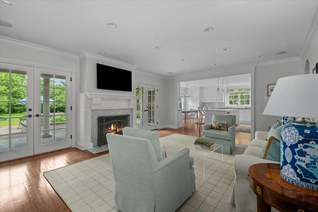 1111 Seneca Rd, Wilmette, IL 60091 - living room with french doors, light wood-type flooring, ornamental molding, a premium fireplace, and recessed lighting