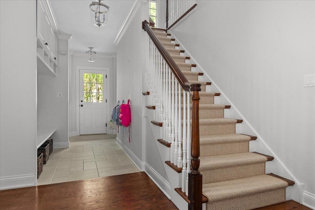 1111 Seneca Rd, Wilmette, IL 60091 - stairs featuring crown molding and wood finished floors