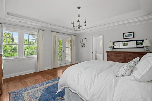 1111 Seneca Rd, Wilmette, IL 60091 - bedroom featuring a raised ceiling, access to exterior, wood finished floors, french doors, and ornamental molding