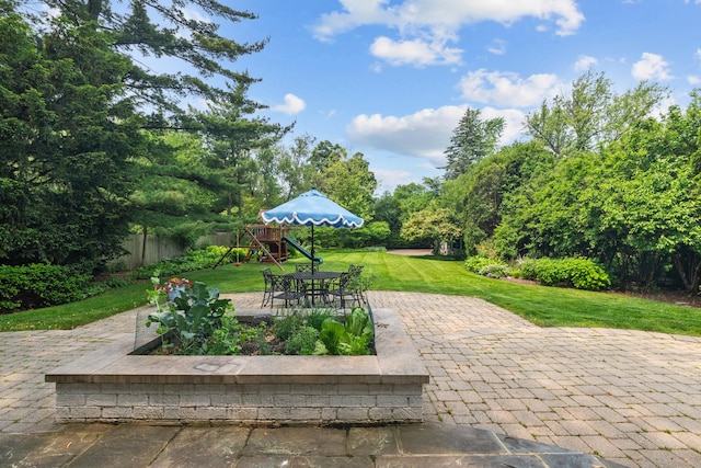 1111 Seneca Rd, Wilmette, IL 60091 - view of patio with a playground and view of wooded area
