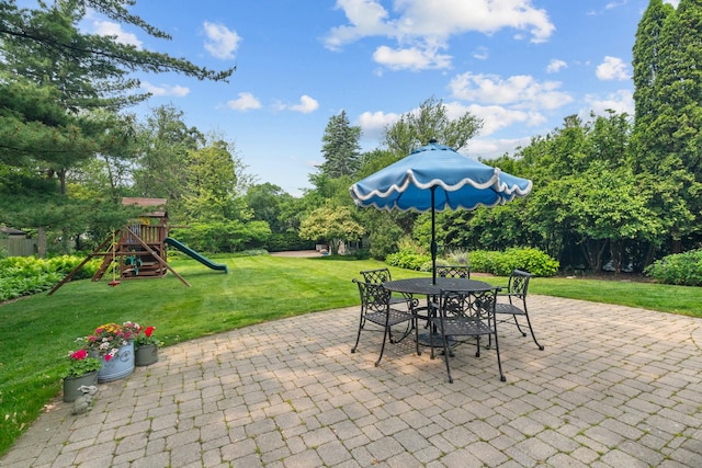 1111 Seneca Rd, Wilmette, IL 60091 - view of patio / terrace featuring outdoor dining space, a playground, and view of wooded area