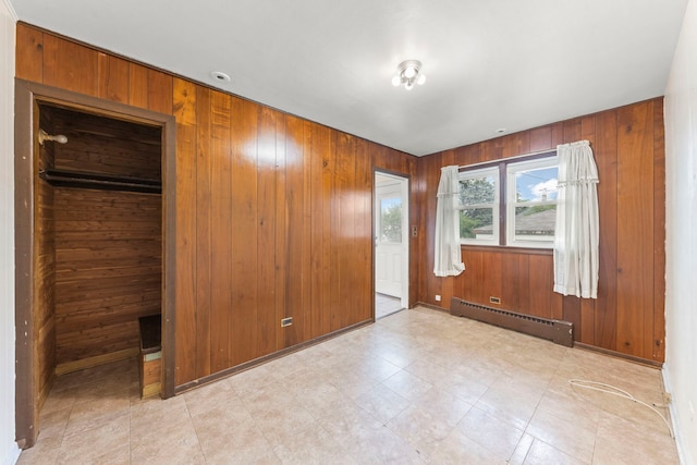 3021 Pearl St, Franklin Park, IL 60131 - unfurnished bedroom with a baseboard heating unit and wooden walls