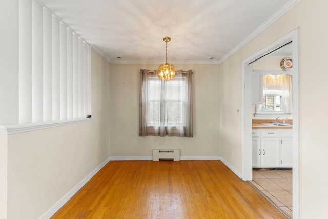 3021 Pearl St, Franklin Park, IL 60131 - unfurnished dining area featuring a baseboard radiator, a chandelier, light wood-style floors, and ornamental molding